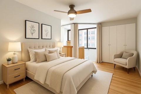 A bedroom with a large bed, a chair, and a ceiling fan.